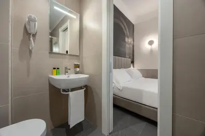 a bedroom with a fireplace and a flat screen tv at Hotel Astoria Garden in Rome