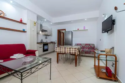 a living room with a red couch and a table at La Casa dei Sogni di Serena in Rome