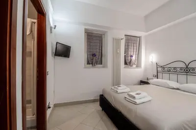 a bedroom with a bed with two towels on it at La Casa dei Sogni di Serena in Rome
