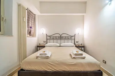 a bedroom with a large bed with two towels on it at La Casa dei Sogni di Serena in Rome