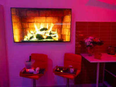 a room with two red chairs and a fireplace at B&B Easy in Rome