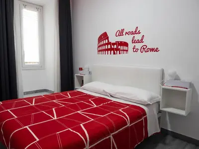 a bedroom with a bed with a red comforter at B&B Easy in Rome