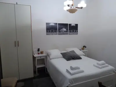 a small bedroom with a bed and a desk at La Dolce Vita Roma in Rome