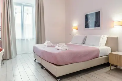 a bedroom with a large bed with towels on it at Guesthouse Sant'Angelo in Rome