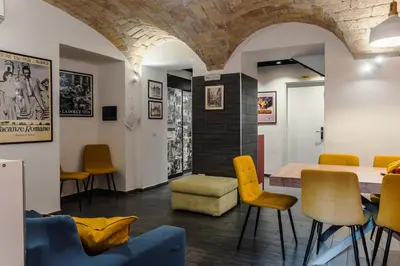 a dining room with a table and yellow chairs at Guesthouse Sant'Angelo in Rome