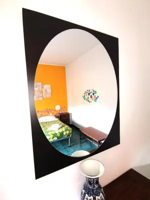 a mirror on the wall of a room with a bed at My Vatican House in Rome