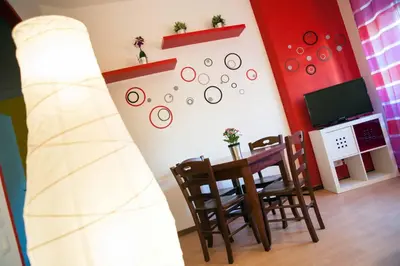 a room with a table and a surfboard on the wall at My Vatican House in Rome