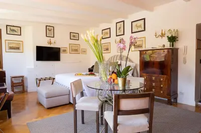 a living room with a table and a dining room at Babuino 79 in Rome