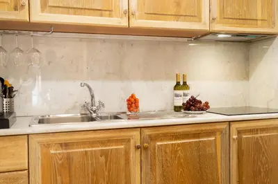a kitchen with wooden cabinets and a sink at Babuino 79 in Rome