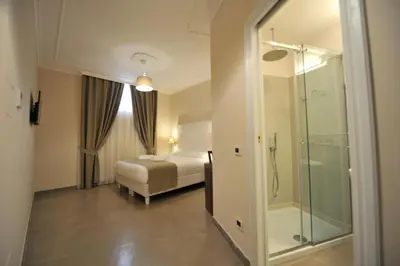 a hotel room with a bed and a glass shower at Villa Zaccardi in Rome