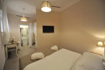 a bedroom with a bed and a television on the wall at Villa Zaccardi in Rome