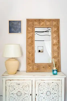 a mirror on top of a dresser with a lamp at SuityRHome RioneMonti56 in Rome