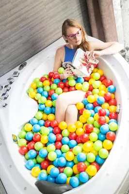 a woman sitting in a tub full of balls at Gregorio VII Luxury Suites in Rome