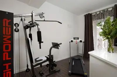 a room with a gym with a treadmill at Gregorio VII Luxury Suites in Rome