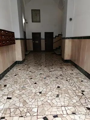 an empty room with a tiled floor in a building at Roma Prince Inn accommodation in Rome