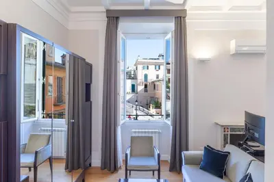 a living room with a couch and chairs and a large window at Internazionale Domus in Rome