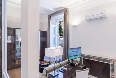 a living room with a desk and a mirror at Internazionale Domus in Rome
