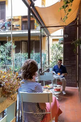 two people sitting at a table on a patio at Boutique Hotel Galatea in Rome