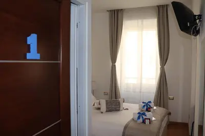 a bedroom with a bed with two presents on it at B&B Gaudium Colosseo in Rome
