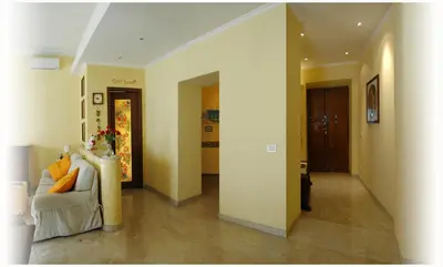 a living room with a white couch and yellow walls at Gaia's Room B&B in Rome