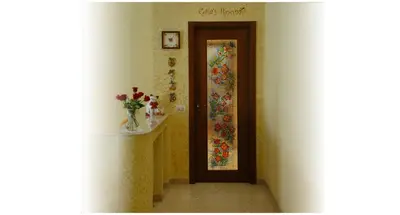 a hallway with a door with a flower quilt on it at Gaia's Room B&B in Rome