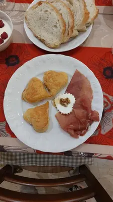 two plates of food on a table with bread at Gaia's Room B&B in Rome