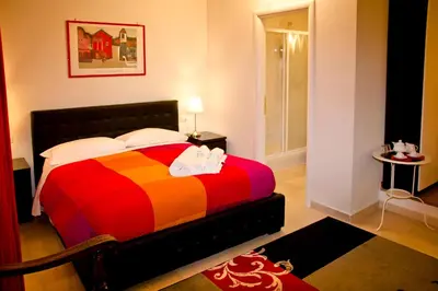 a bedroom with a bed with a colorful blanket at Vatican Dream in Rome