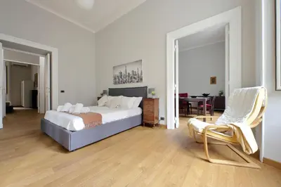 a bedroom with a bed and a chair and a table at 4BNB - Spacious Belli Apartment in Rome