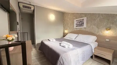 a hotel room with a bed with towels on it at Hotel Concorde in Rome