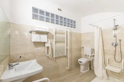 a bathroom with a toilet and a sink and a shower at Hotel Tempio Di Pallade in Rome