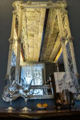 a mirror sitting on top of a table at Il Covo B&B in Rome