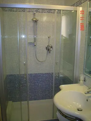 a bathroom with a glass shower and a sink at Hotel Dina in Rome