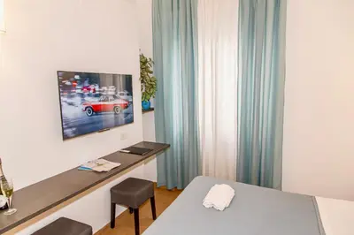 a bedroom with a bed with two blue pillows at Internouno in Rome