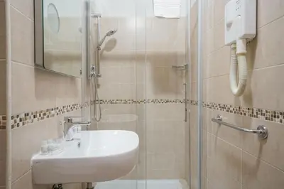 a bathroom with a sink and a shower at Hotel St. Moritz in Rome