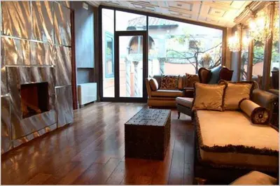 a living room with a couch and a fireplace at San Anselmo in Rome