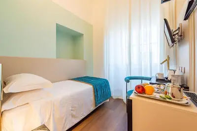 a bedroom with a bed and a table with fruits on it at Best Western Hotel Artdeco in Rome