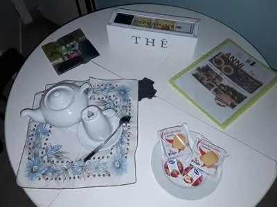 a table topped with a tea pot and a magazine at B&B Anni 50 in Rome