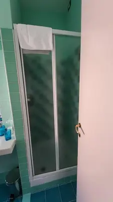 a shower with a glass door in a bathroom at B&B Anni 50 in Rome