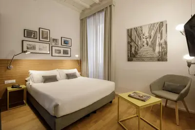 a hotel room with a bed and a chair at Coronari Palace in Rome