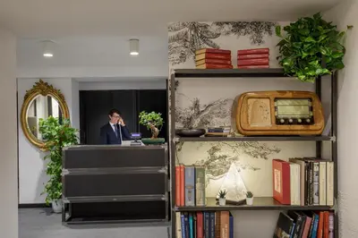 a man talking on a phone in a room with books at Coronari Palace in Rome