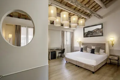 a bedroom with a white bed and a mirror at Condotti Palace in Rome