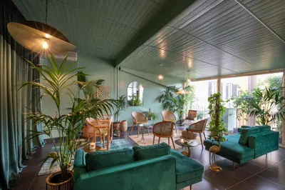 a living room with green furniture and plants at Condotti Palace in Rome