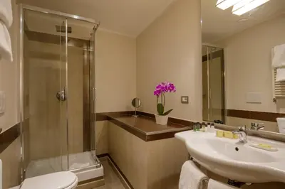 a bathroom with a sink and a shower and a toilet at Condotti Palace in Rome