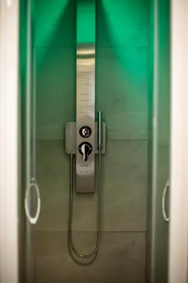 a glass door with a shower in a bathroom at Hotel Cinquantatre in Rome