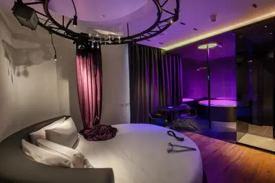 a bedroom with a white bed and purple lighting at SuiteSistina for Brave Lovers in Rome