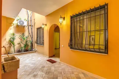 a hallway with a yellow wall with a gate at Hotel Artorius in Rome