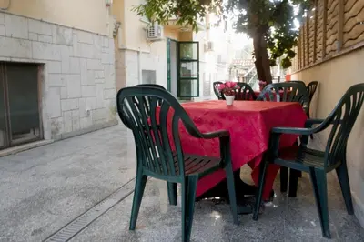 a table with chairs and a red table cloth at Hotel Antico Acquedotto in Rome