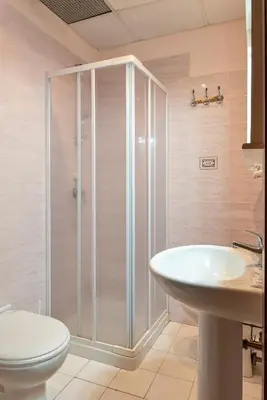 a bathroom with a shower and a toilet and a sink at Hotel Ventura in Rome
