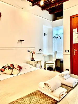 a bedroom with a large bed with towels on it at Domus Ester in Rome