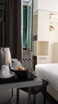a hotel room with a tray of food on a table at Crosti Hotel in Rome
